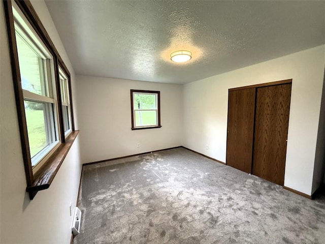 31050 US Highway 322, Cochranton, PA 16314 - unfurnished bedroom with baseboards, carpet, a textured ceiling, and a closet