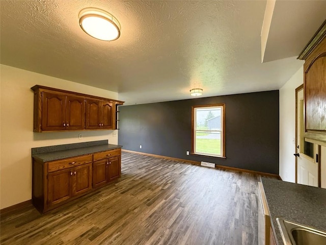 31050 US Highway 322, Cochranton, PA 16314 - kitchen with dark countertops, dark wood-type flooring, a textured ceiling, baseboards, and a sink