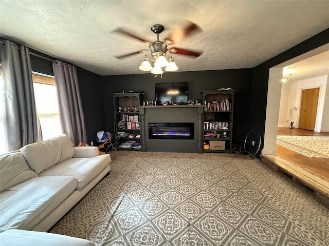 10537 Franklin Pike, Meadville, PA 16335 - living room featuring a ceiling fan, a glass covered fireplace, and a textured ceiling
