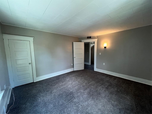 917 Walnut St, Erie, PA 16502 - empty room featuring dark colored carpet and baseboards