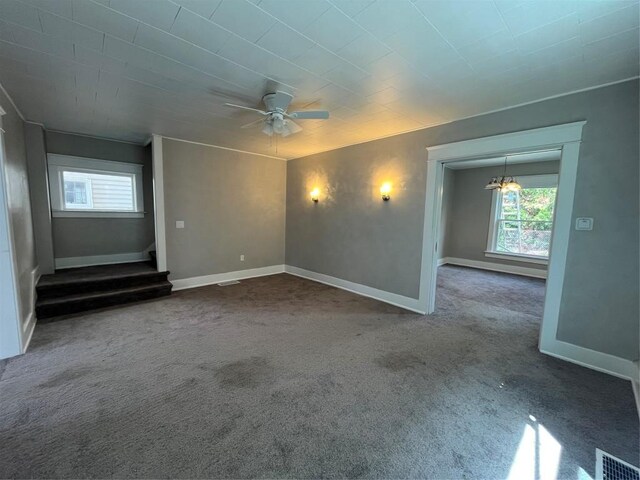 917 Walnut St, Erie, PA 16502 - unfurnished living room featuring plenty of natural light, stairs, baseboards, and dark carpet
