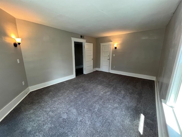 917 Walnut St, Erie, PA 16502 - empty room featuring dark colored carpet and baseboards