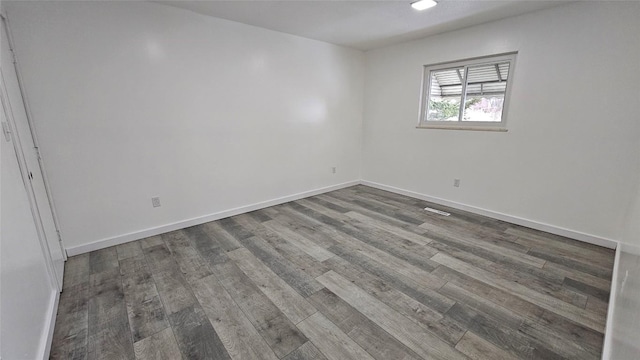 unfurnished room with hardwood / wood-style flooring