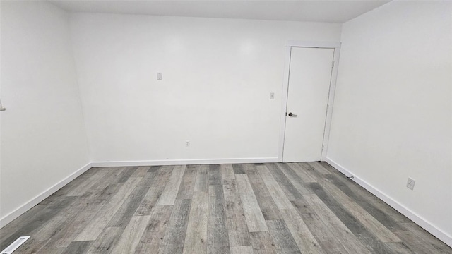 empty room featuring wood-type flooring