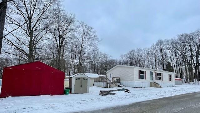 exterior space with a storage shed and an outbuilding