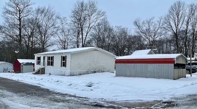 exterior space with an outbuilding and a detached garage