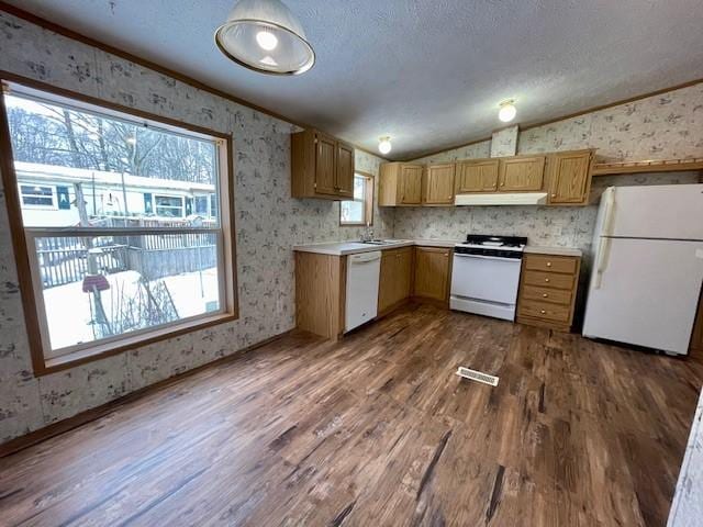 kitchen with lofted ceiling, white appliances, under cabinet range hood, and wallpapered walls