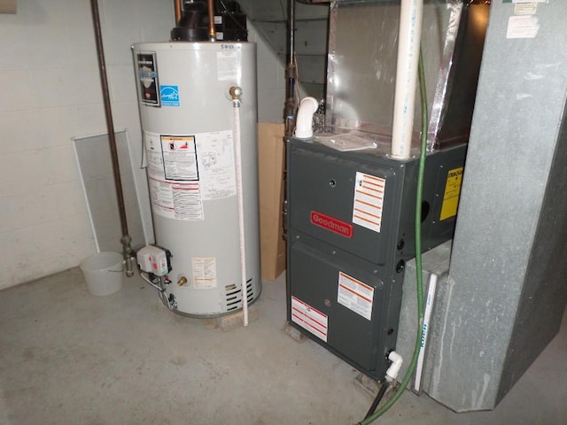 utility room featuring heating unit and gas water heater