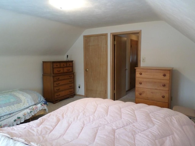 carpeted bedroom with vaulted ceiling