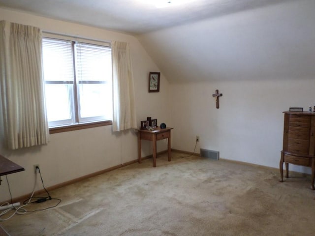 bonus room featuring vaulted ceiling and light carpet