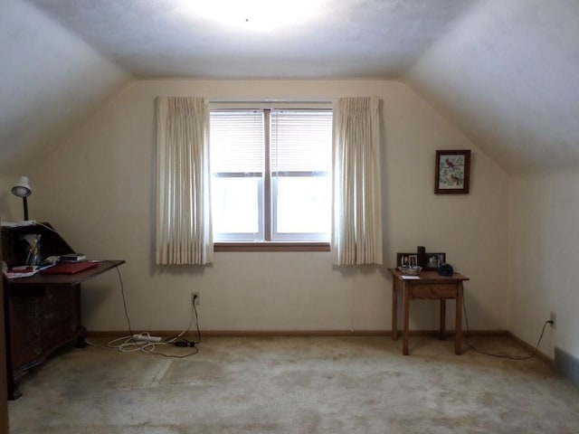 bonus room with light carpet and lofted ceiling