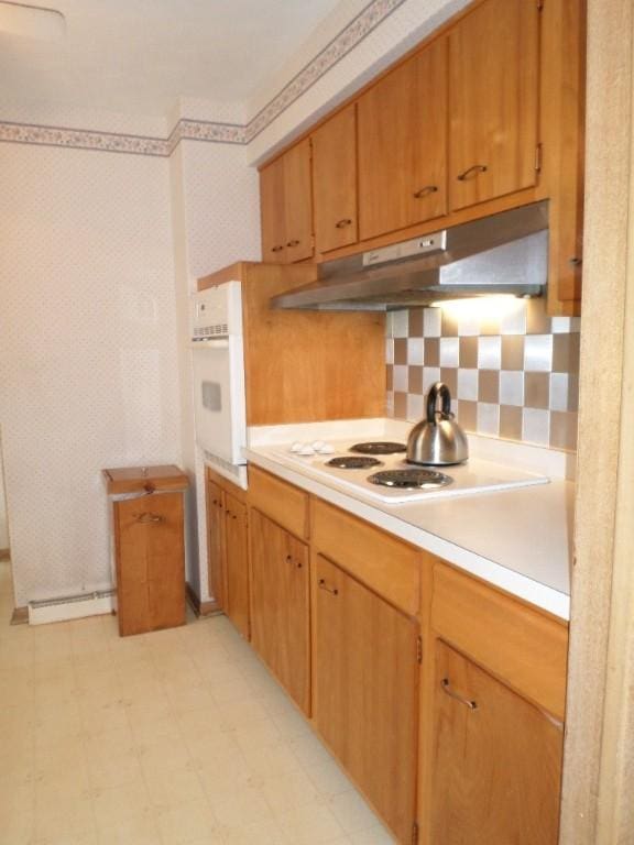 kitchen with white appliances and decorative backsplash