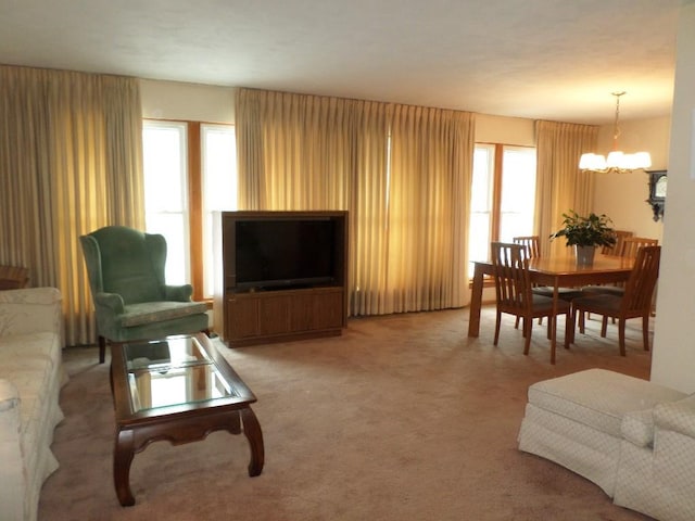 living room featuring carpet floors and a notable chandelier