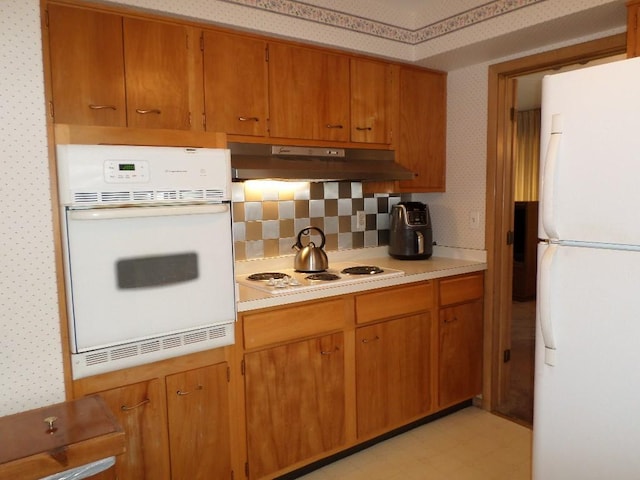 kitchen featuring white appliances and decorative backsplash