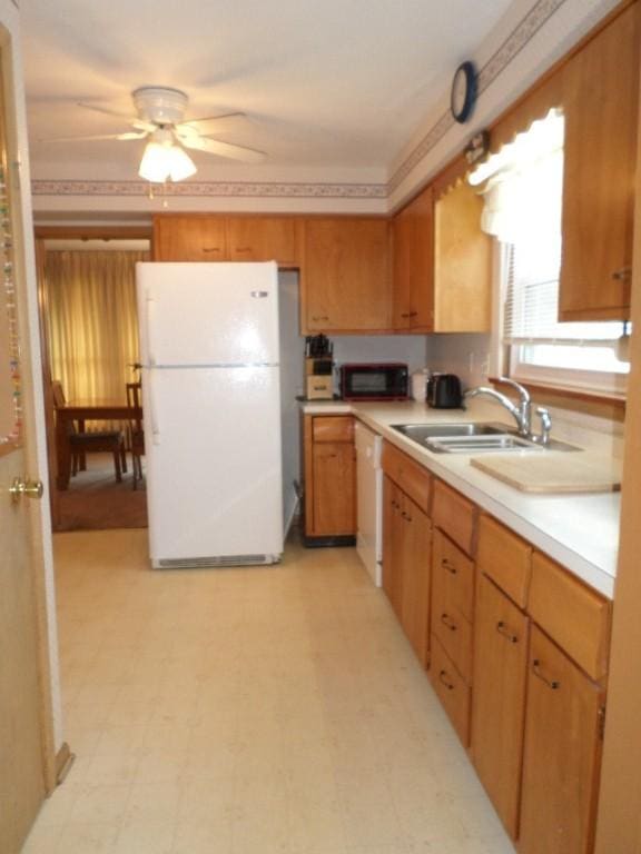 kitchen with ceiling fan, white appliances, and sink