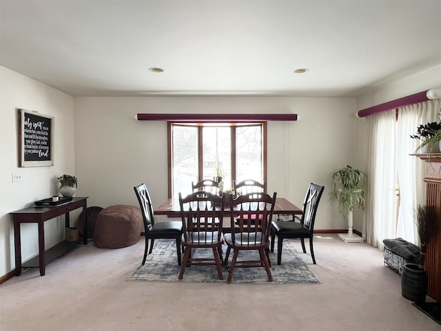 dining area with light carpet and a wealth of natural light