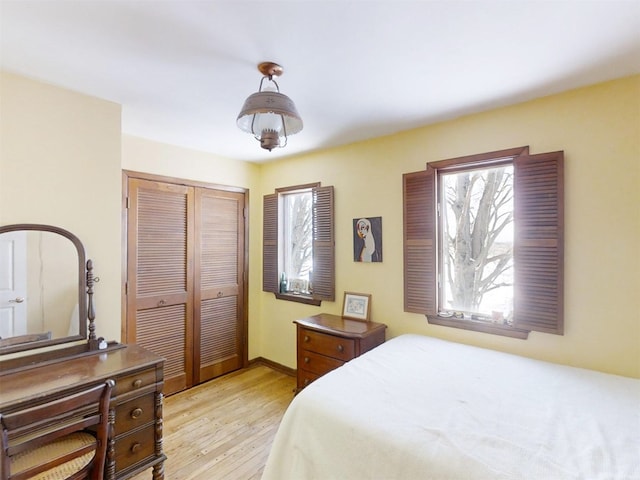 bedroom featuring light hardwood / wood-style floors and a closet