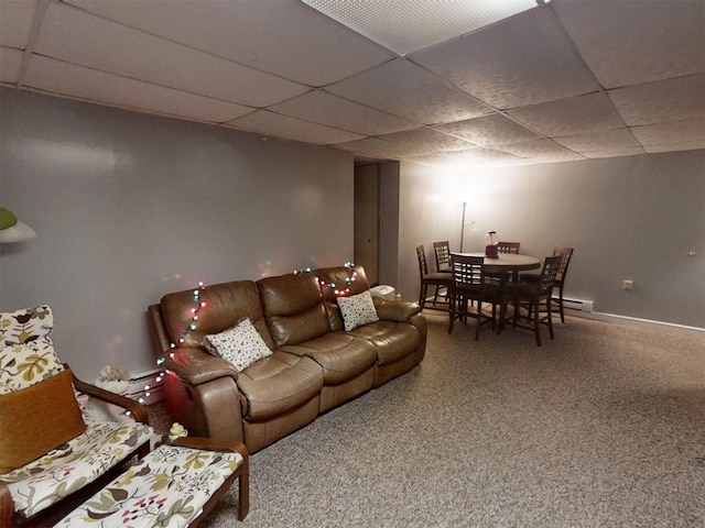 carpeted living room with a baseboard heating unit and a drop ceiling