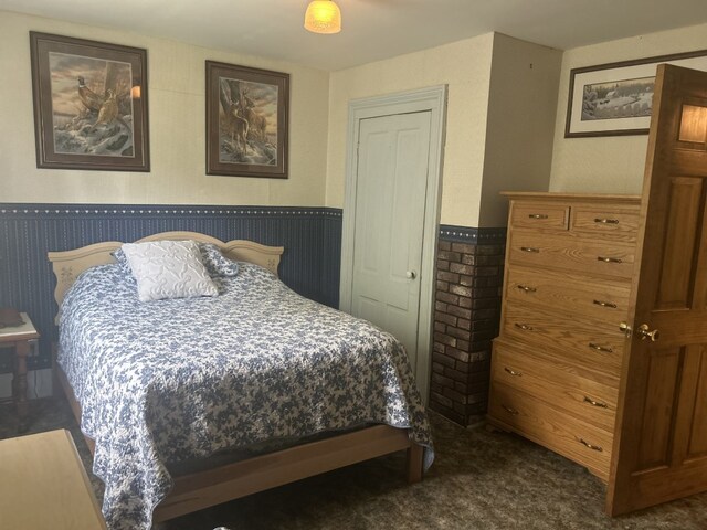 495 E Jamestown Rd, Greenville, PA 16125 - bedroom with a wainscoted wall and dark carpet
