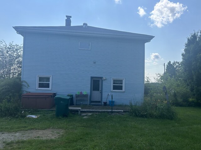 495 E Jamestown Rd, Greenville, PA 16125 - back of property featuring a hot tub, a chimney, and a yard