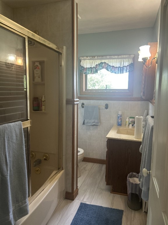 495 E Jamestown Rd, Greenville, PA 16125 - bathroom featuring vanity, bath / shower combo with glass door, and tile walls