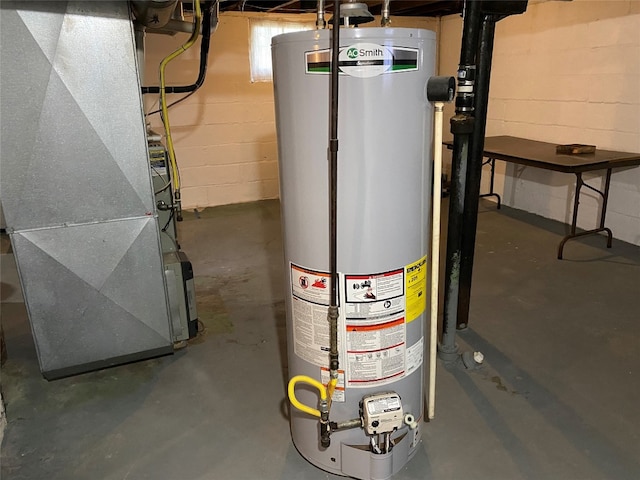 utility room featuring heating unit and gas water heater