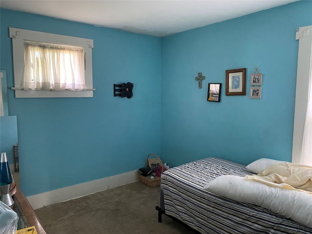 bedroom featuring baseboards and carpet floors