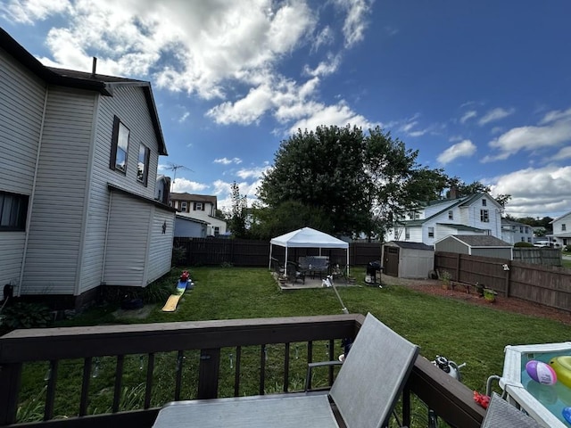 view of yard featuring a gazebo and a storage unit