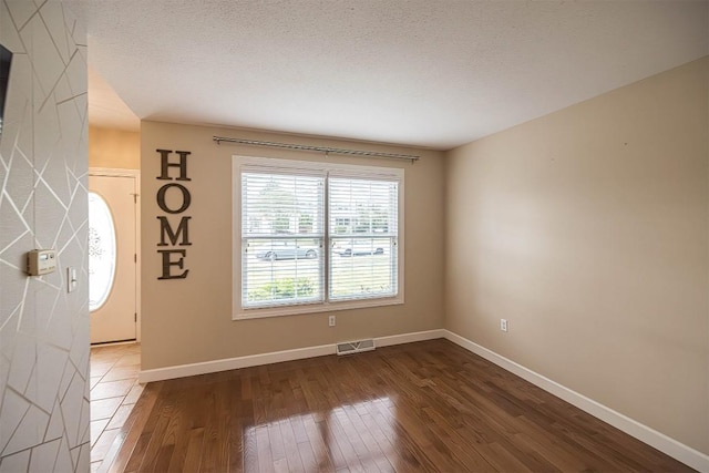2861 S Birch Run, Millcreek, PA 16506 - empty room featuring dark wood finished floors and a textured ceiling