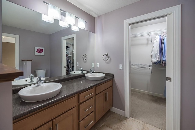 2861 S Birch Run, Millcreek, PA 16506 - bathroom with double vanity, a walk in closet, and tile patterned floors