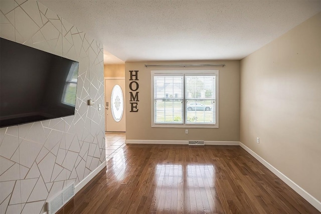 2861 S Birch Run, Millcreek, PA 16506 - unfurnished living room with a textured ceiling and wood finished floors