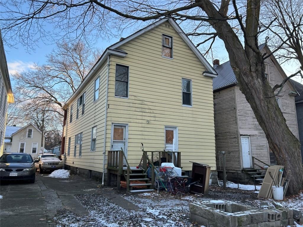 view of snow covered rear of property