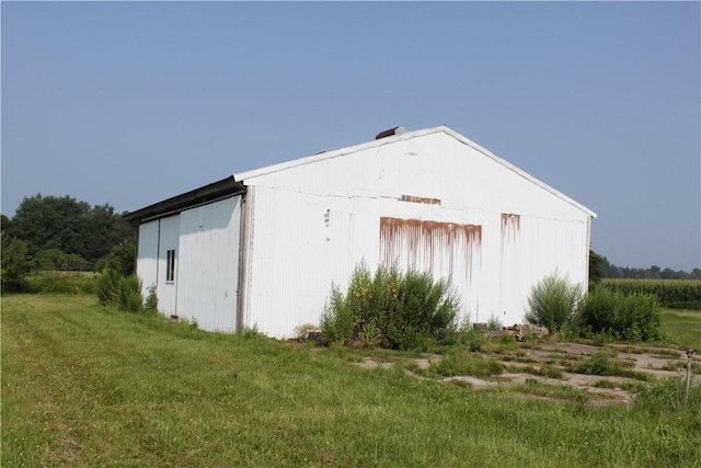 view of outbuilding featuring a lawn