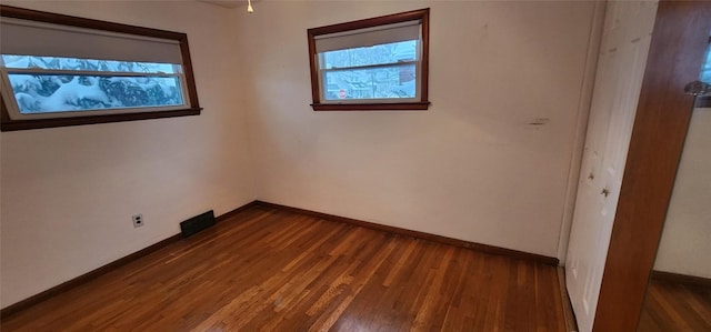 spare room featuring dark wood-type flooring