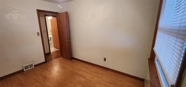 empty room with light hardwood / wood-style flooring