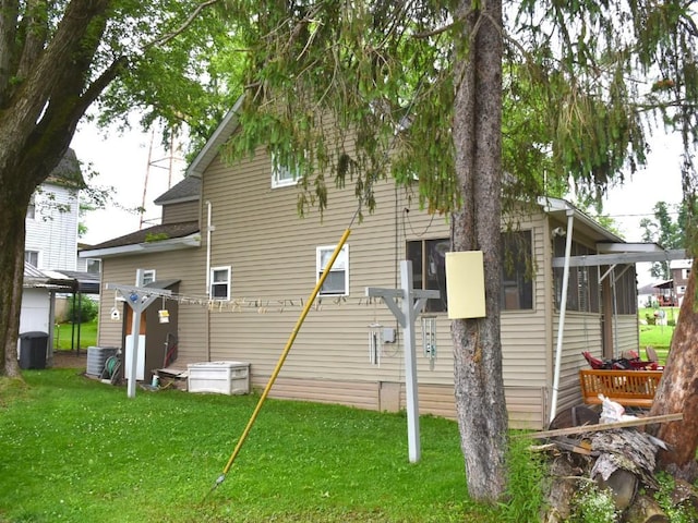 10987 Henry St, Conneaut Lake, PA 16316 - view of side of home featuring a lawn and a sunroom