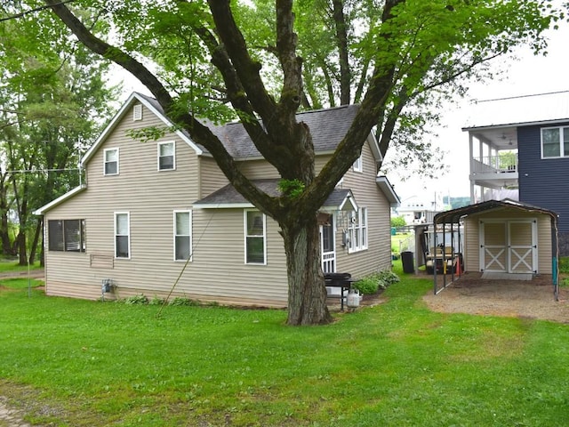 10987 Henry St, Conneaut Lake, PA 16316 - back of property featuring roof with shingles, a lawn, a garage, and a shed