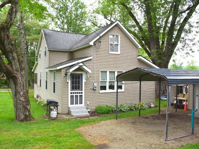 10987 Henry St, Conneaut Lake, PA 16316 - view of front of house with entry steps, a detached carport, a shingled roof, and a front yard