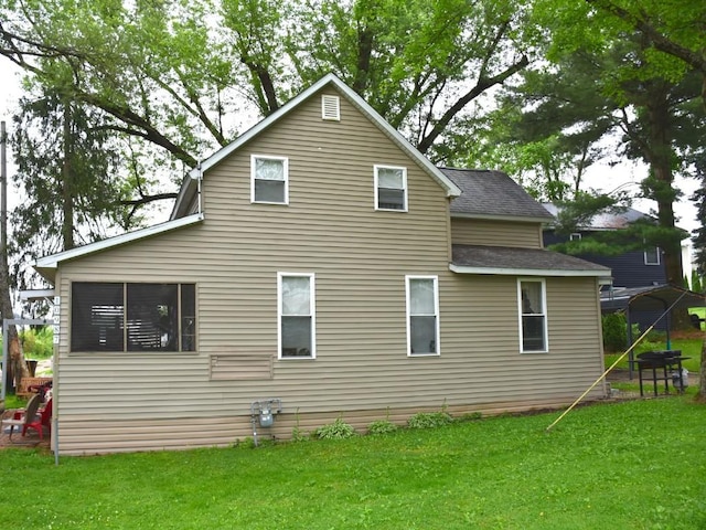 10987 Henry St, Conneaut Lake, PA 16316 - back of house with roof with shingles and a yard