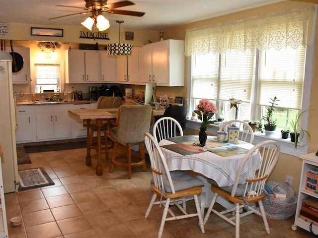 10987 Henry St, Conneaut Lake, PA 16316 - dining room featuring a ceiling fan and light tile patterned flooring