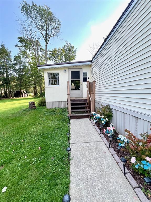 50 Maplenut Ln, Erie, PA 16510 - view of exterior entry featuring a lawn