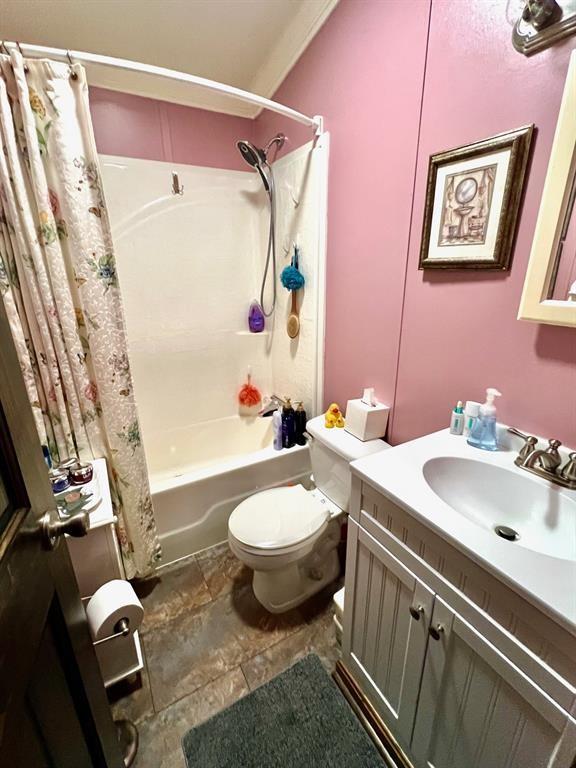 50 Maplenut Ln, Erie, PA 16510 - bathroom with toilet, shower / bathtub combination with curtain, vanity, and stone finish floors