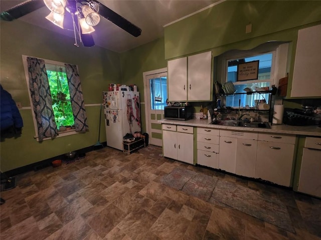 340 W 24th St, Erie, PA 16502 - kitchen with freestanding refrigerator, stone finish floors, ceiling fan, stainless steel microwave, and white cabinetry