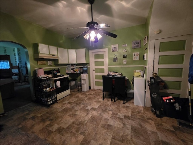 340 W 24th St, Erie, PA 16502 - kitchen with electric range, white cabinetry, a ceiling fan, stone finish flooring, and arched walkways