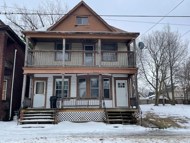 view of front of house featuring covered porch and a balcony