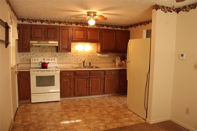 kitchen with a textured ceiling, ceiling fan, white appliances, and sink