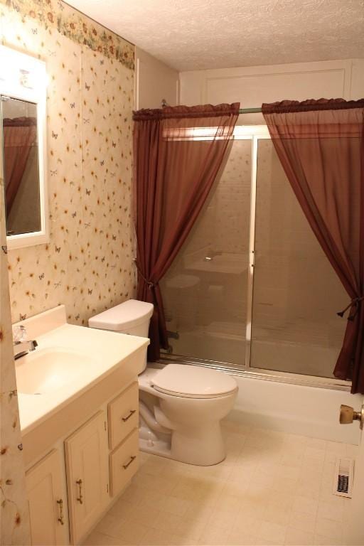 full bathroom with vanity, toilet, enclosed tub / shower combo, and a textured ceiling