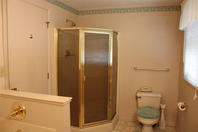 bathroom featuring toilet and an enclosed shower