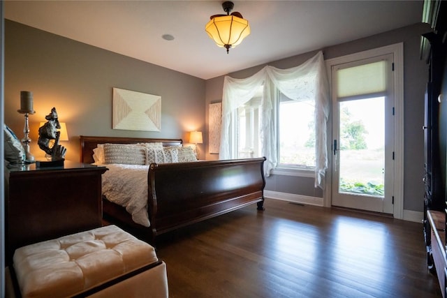 bedroom with dark hardwood / wood-style flooring