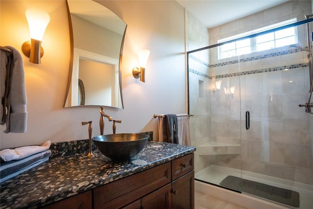 bathroom featuring vanity and a shower with shower door